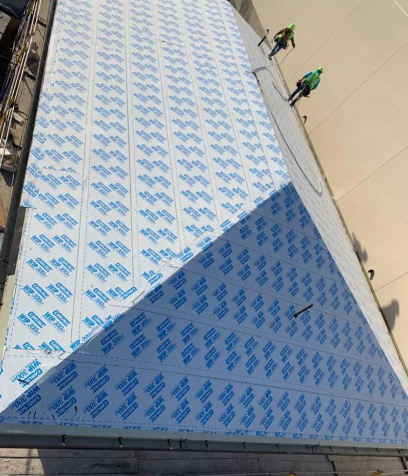 Professional roofers installing underlayment on a metal roof in Casa Grande